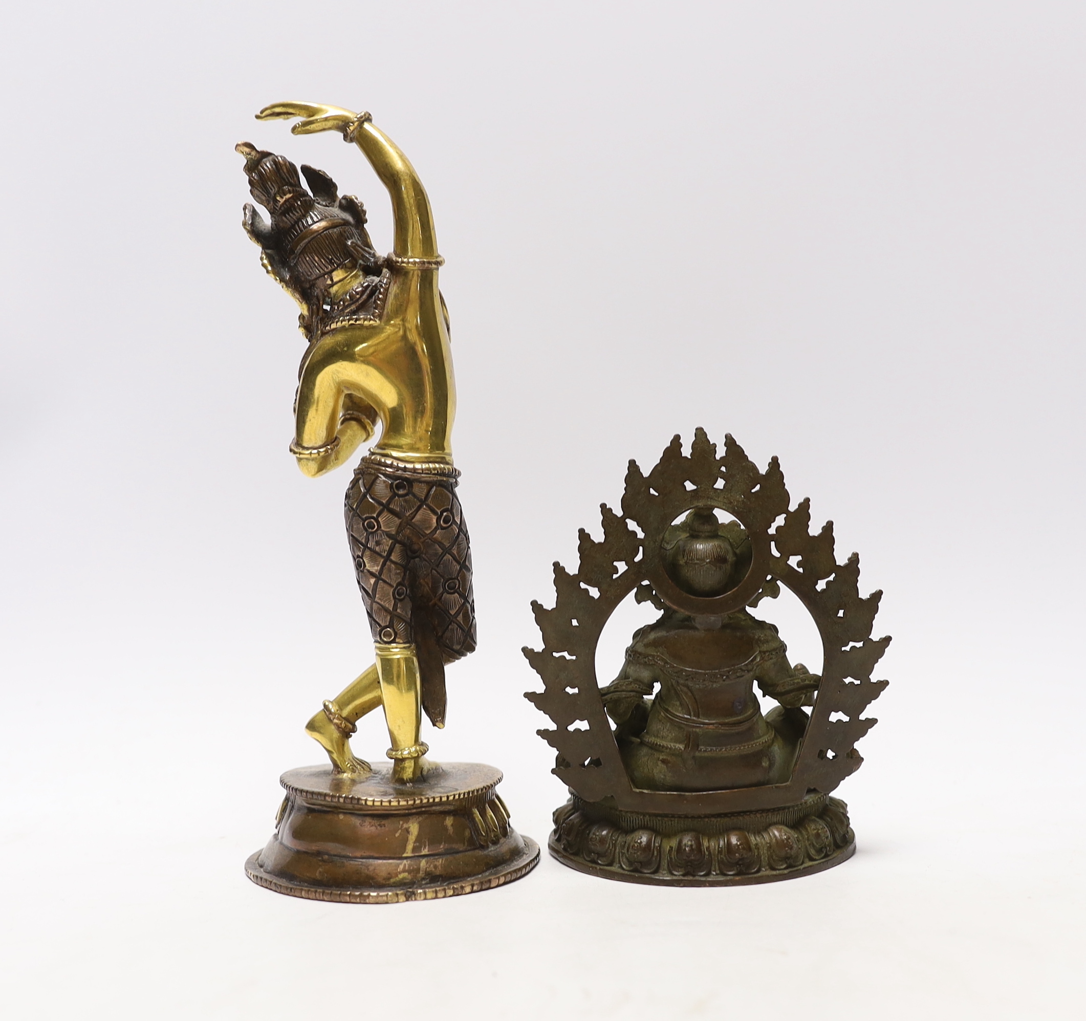 A Tibetan gilt bronze figure of Maya, Queen of Shakya, 20.5cm high, and a Tibetan figure of Jambhala surrounded by flames, 11.5cm